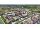 Beautiful aerial view of a neighborhood featuring well-manicured lawns, mature trees and access to a community pond at 32203 Wenlock Loop, Wesley Chapel, FL 33543