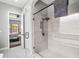 Main bathroom features a glass-enclosed shower and bathtub with an open doorway to bedroom at 32203 Wenlock Loop, Wesley Chapel, FL 33543