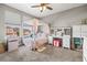 A bedroom featuring a canopy bed, desk, and window with natural light at 32203 Wenlock Loop, Wesley Chapel, FL 33543