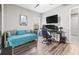 Cozy bedroom featuring wood floors, a daybed, a workstation, and a ceiling fan at 32203 Wenlock Loop, Wesley Chapel, FL 33543