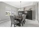 Elegant dining room with modern light fixture and table with seating for six at 32203 Wenlock Loop, Wesley Chapel, FL 33543