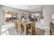 Bright dining room with wood table and view into the kitchen and outdoor patio at 32203 Wenlock Loop, Wesley Chapel, FL 33543