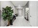 Spacious foyer with tile flooring, a staircase, and a decorative plant at 32203 Wenlock Loop, Wesley Chapel, FL 33543