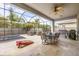 A screened patio features a dining table, grill, seating area, and jacuzzi at 32203 Wenlock Loop, Wesley Chapel, FL 33543