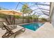 Enclosed pool area with lounge chairs and umbrella; great for relaxing at 32203 Wenlock Loop, Wesley Chapel, FL 33543