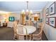 Casual dining area with wicker chairs and view to kitchen and other living areas at 36750 Us 19 N Hwy # 18-210, Palm Harbor, FL 34684