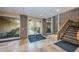 Inviting entryway features brick accents, tiled floors, and lush landscaping views through large windows at 36750 Us 19 N Hwy # 18-210, Palm Harbor, FL 34684