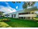 Well-maintained building exterior with manicured lawn and tidy landscaping at 36750 Us 19 N Hwy # 18-210, Palm Harbor, FL 34684