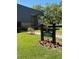 Welcome to Portmarnock Lodge 18, featuring a beautifully landscaped entrance with colorful flowers at 36750 Us 19 N Hwy # 18-210, Palm Harbor, FL 34684