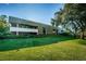 Well-maintained building exterior with a lush lawn, mature tree and tidy shrubs at 36750 Us 19 N Hwy # 18-210, Palm Harbor, FL 34684