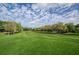 Expansive golf course views with lush green fairways and a clear blue sky, perfect for a relaxing game at 36750 Us 19 N Hwy # 18-210, Palm Harbor, FL 34684