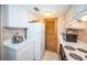 White kitchen with modern appliances, white countertops, and tiled floors at 36750 Us 19 N Hwy # 18-210, Palm Harbor, FL 34684