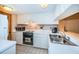 Bright kitchen features white cabinetry, modern appliances and tile backsplash at 36750 Us 19 N Hwy # 18-210, Palm Harbor, FL 34684