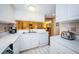 Kitchen with stainless steel appliances and white cabinets, open to the dining area at 36750 Us 19 N Hwy # 18-210, Palm Harbor, FL 34684