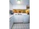 Well-lit kitchen with modern appliances and a view into the dining and living areas at 36750 Us 19 N Hwy # 18-210, Palm Harbor, FL 34684