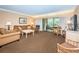 Comfortable living room features balcony access, neutral tones, and cozy furnishings at 36750 Us 19 N Hwy # 18-210, Palm Harbor, FL 34684