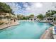 Resort-style pool features a rock waterfall, ample seating, and lush landscaping for a relaxing retreat at 36750 Us 19 N Hwy # 18-210, Palm Harbor, FL 34684