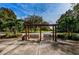 Inviting outdoor swings set among mature trees and landscaping create a peaceful park setting at 36750 Us 19 N Hwy # 18-210, Palm Harbor, FL 34684