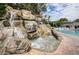The community pool has a rocky waterfall and spa, creating a resort-like experience at 36750 Us 19 N Hwy # 18-210, Palm Harbor, FL 34684