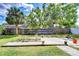 Secluded backyard offering a wooden platform with garden beds, a charming fence, and ample green space for recreation at 4110 Summerdale Dr, Tampa, FL 33624