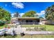Expansive backyard featuring a screened lanai, a wooden deck, and vibrant landscaping, perfect for outdoor entertaining at 4110 Summerdale Dr, Tampa, FL 33624