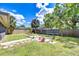 Expansive backyard with lush lawn, features a stone walkway and garden beds for outdoor enjoyment at 4110 Summerdale Dr, Tampa, FL 33624