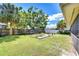 Well-maintained backyard with a wooden fence, tropical plants, and a wooden platform for gardening or relaxation at 4110 Summerdale Dr, Tampa, FL 33624