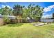 Private backyard featuring a wooden fence, palm trees, and a wooden platform, providing a serene outdoor living space at 4110 Summerdale Dr, Tampa, FL 33624