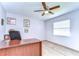 Cozy room has a wood-look floor, ceiling fan, and a window letting in natural light, perfect for relaxation at 4110 Summerdale Dr, Tampa, FL 33624