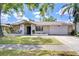 Charming single-story home with stone accents, a two-car garage, and well-maintained lawn at 4110 Summerdale Dr, Tampa, FL 33624