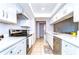 Updated kitchen featuring modern white cabinets, quartz countertops, and stainless steel appliances at 4110 Summerdale Dr, Tampa, FL 33624