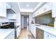 Updated kitchen featuring modern white cabinets, quartz countertops, and stainless steel appliances at 4110 Summerdale Dr, Tampa, FL 33624