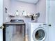 The laundry area features a washer, dryer, and shelving for organization and efficiency at 4110 Summerdale Dr, Tampa, FL 33624