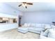 Bright living room featuring a large sectional sofa and access to the kitchen area at 4110 Summerdale Dr, Tampa, FL 33624