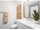 Bright bathroom featuring white vanity, and a large mirror, next to a toilet at 4511 S Manhattan Ave # 20, Tampa, FL 33611