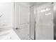 Bright bathroom with glass shower, white tile, and modern vanity at 4511 S Manhattan Ave # 20, Tampa, FL 33611