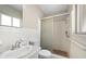 Bathroom featuring sink, toilet and shower with sliding glass door at 6470 28Th N Ter, St Petersburg, FL 33710