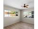 Bedroom with wood-look floors, ceiling fan, and windows with outdoor views at 6470 28Th N Ter, St Petersburg, FL 33710