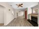 Bright living room featuring wood floors, fireplace, ceiling fan, and open archways at 6470 28Th N Ter, St Petersburg, FL 33710