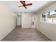 Bedroom with wood-look floors, ceiling fan and a view to the main bathroom at 6470 28Th N Ter, St Petersburg, FL 33710