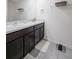 Clean bathroom featuring double sinks, dark wood cabinets, and modern gray tile floors at 659 Sunlit Coral St, Ruskin, FL 33570