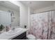 Fresh bathroom featuring a shower with floral curtains, a vanity with a mirror and decor at 659 Sunlit Coral St, Ruskin, FL 33570