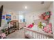 Cheerful bedroom with colorful wall decor, a bed with plush toys, and play furniture at 659 Sunlit Coral St, Ruskin, FL 33570