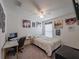 Bright bedroom showcasing gaming decor, computer desk, ceiling fan and neutral gray carpet at 659 Sunlit Coral St, Ruskin, FL 33570