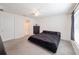 Neutral bedroom featuring a ceiling fan, light gray carpet, and a queen size bed at 659 Sunlit Coral St, Ruskin, FL 33570