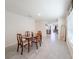 Bright dining area with tile flooring, a wooden table set, and an open view to other living spaces at 659 Sunlit Coral St, Ruskin, FL 33570