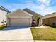 Charming single-story home with a two-car garage, well-maintained lawn, and landscaped front yard at 659 Sunlit Coral St, Ruskin, FL 33570