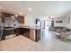 Modern kitchen featuring dark wood cabinets, stainless steel appliances, and an open layout at 659 Sunlit Coral St, Ruskin, FL 33570