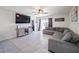 Spacious living room with tile floors, a large TV, and comfortable seating for relaxing and entertaining at 659 Sunlit Coral St, Ruskin, FL 33570