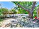 Tranquil backyard featuring a pergola, mature trees, and ample space for outdoor enjoyment and relaxation at 700 16Th Nw St, Largo, FL 33770